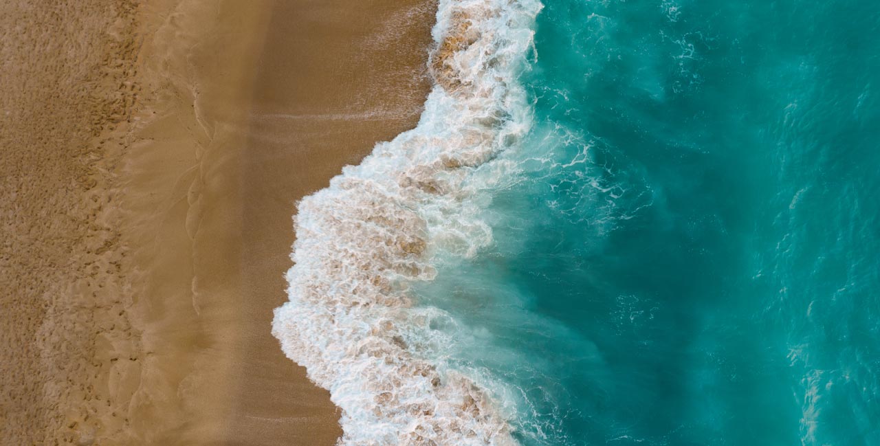 Top view of sand meeting seawater